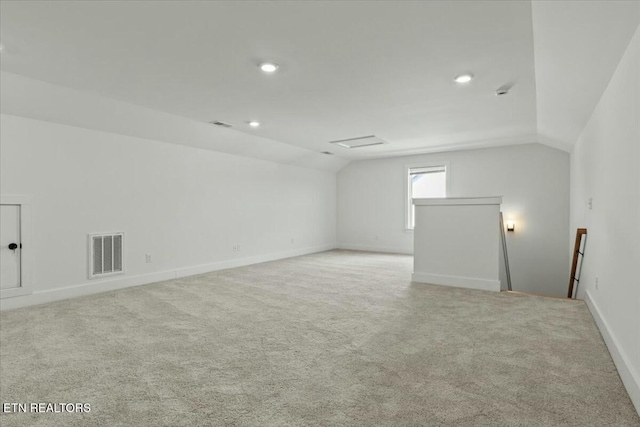 interior space featuring recessed lighting, visible vents, lofted ceiling, and carpet floors