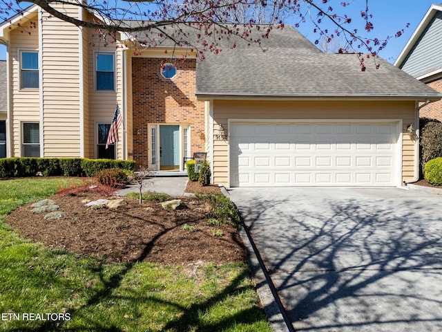 view of front of home featuring driveway, brick siding, an attached garage, and a shingled roof