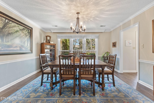 dining space with visible vents, baseboards, an inviting chandelier, and wood finished floors