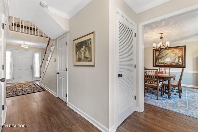 entryway with baseboards, crown molding, an inviting chandelier, and dark wood-style flooring