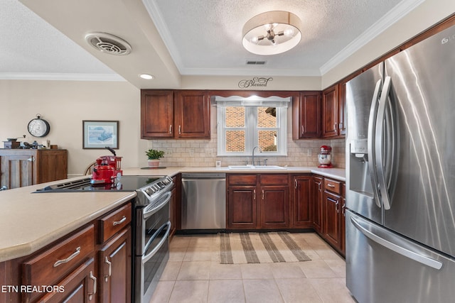 kitchen with visible vents, appliances with stainless steel finishes, light countertops, and a sink