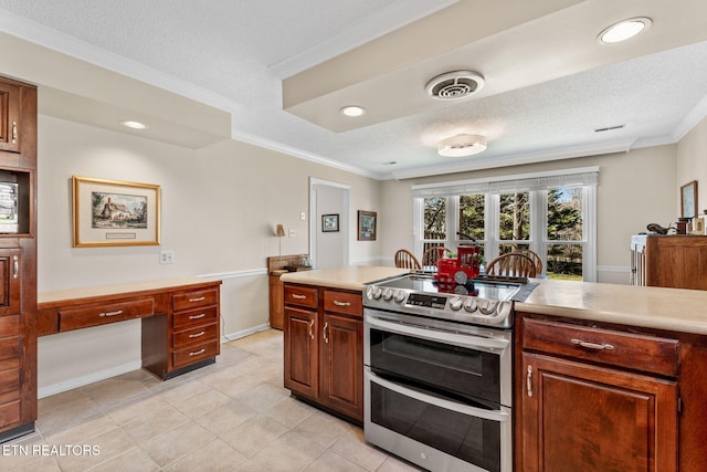 kitchen featuring light countertops, crown molding, double oven range, and visible vents