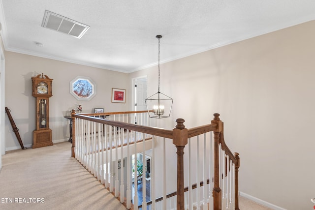 stairway with baseboards, visible vents, carpet floors, ornamental molding, and a notable chandelier