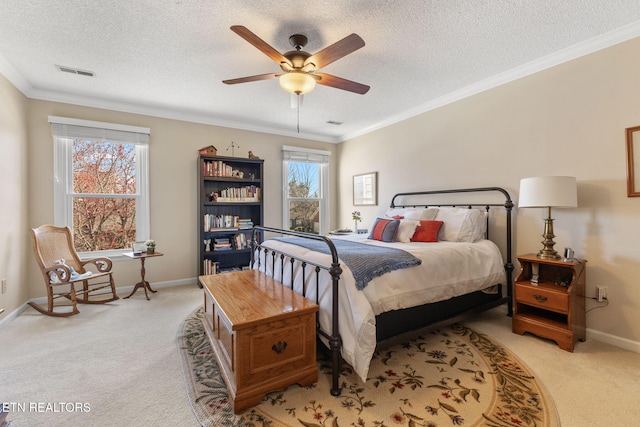 bedroom featuring visible vents, multiple windows, and light colored carpet