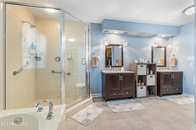 full bath featuring vanity, baseboards, tile patterned flooring, a shower stall, and a bath