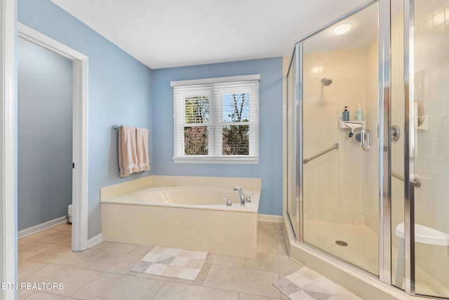 full bath featuring tile patterned floors, a shower stall, and a bath