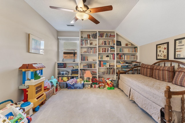 interior space featuring a ceiling fan, carpet, visible vents, lofted ceiling, and a textured ceiling