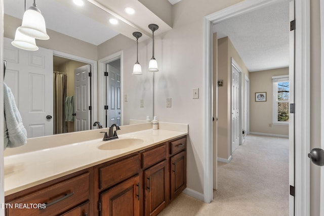 full bathroom with baseboards and vanity