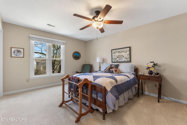 bedroom featuring visible vents, baseboards, a textured ceiling, and carpet flooring