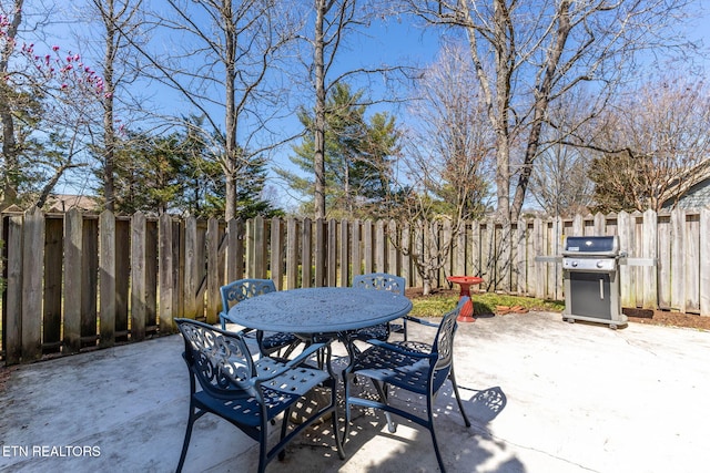 view of patio / terrace with area for grilling, outdoor dining area, and a fenced backyard