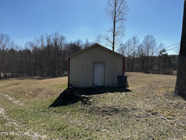 view of shed featuring a view of trees