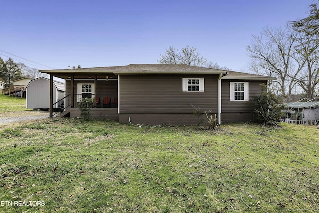 view of front of property with a storage shed, an outbuilding, a front lawn, and crawl space