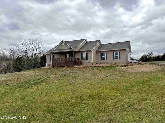 view of front of property with a shingled roof, a front yard, covered porch, and crawl space