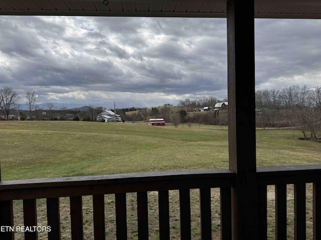 view of yard with a mountain view and a rural view