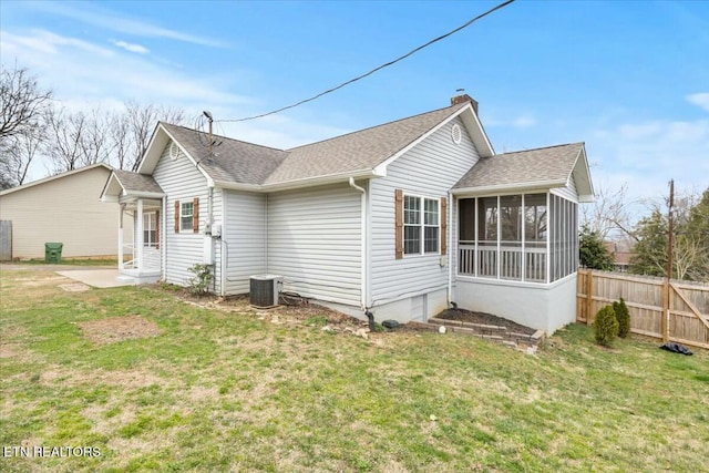 view of side of property with a sunroom, fence, central AC, and a shingled roof