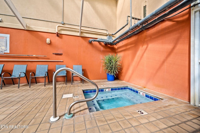 view of pool featuring a patio area and an indoor in ground hot tub