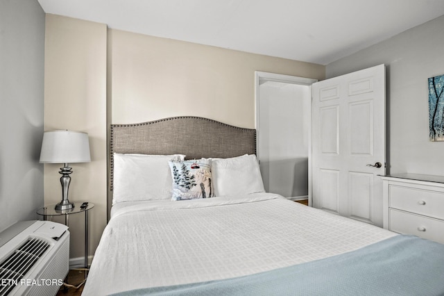 bedroom featuring a wall unit AC