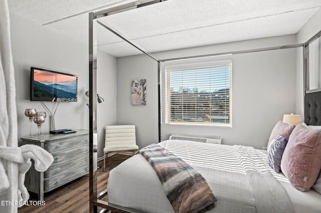 bedroom featuring an AC wall unit and wood finished floors