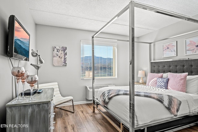 bedroom featuring hardwood / wood-style flooring and baseboards