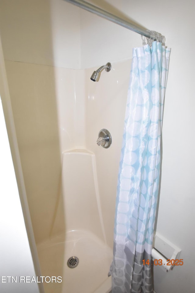 bathroom with a shower with curtain