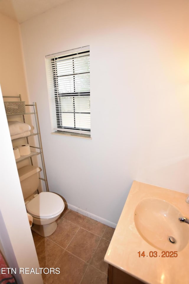 bathroom featuring tile patterned floors, toilet, vanity, and baseboards