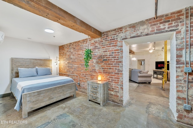 bedroom with beam ceiling, brick wall, and concrete floors