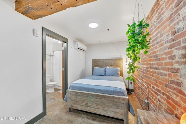 bedroom with brick wall, ensuite bathroom, and a wall mounted AC