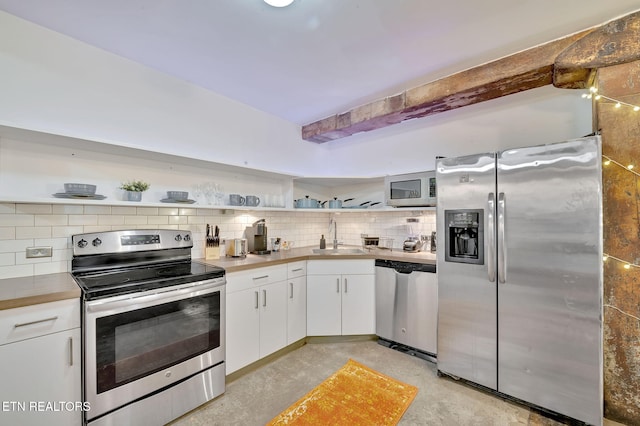 kitchen with backsplash, open shelves, stainless steel appliances, and a sink