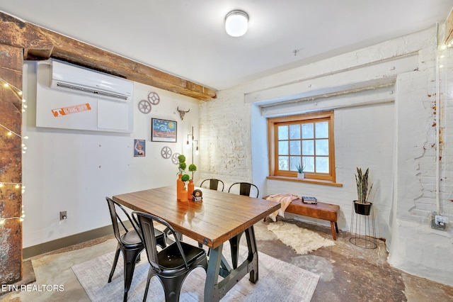 dining space with baseboards, concrete flooring, and a wall mounted AC