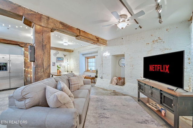 living room featuring beamed ceiling, ceiling fan, and rail lighting