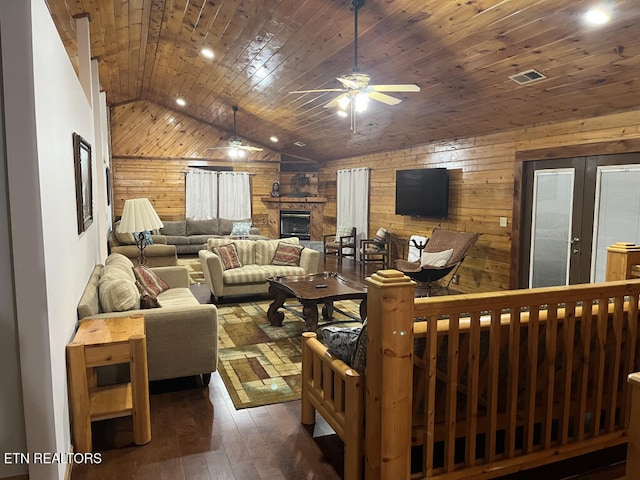 living room with wooden walls, ceiling fan, wood ceiling, vaulted ceiling, and hardwood / wood-style flooring