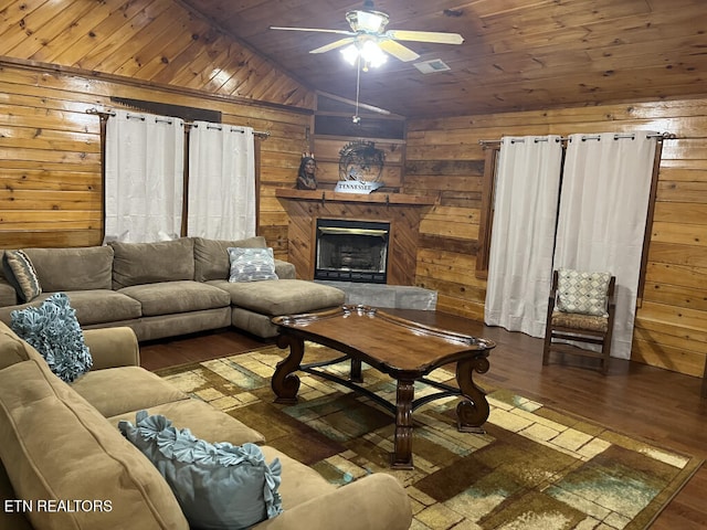 living room with wooden walls, wood ceiling, a ceiling fan, and hardwood / wood-style floors