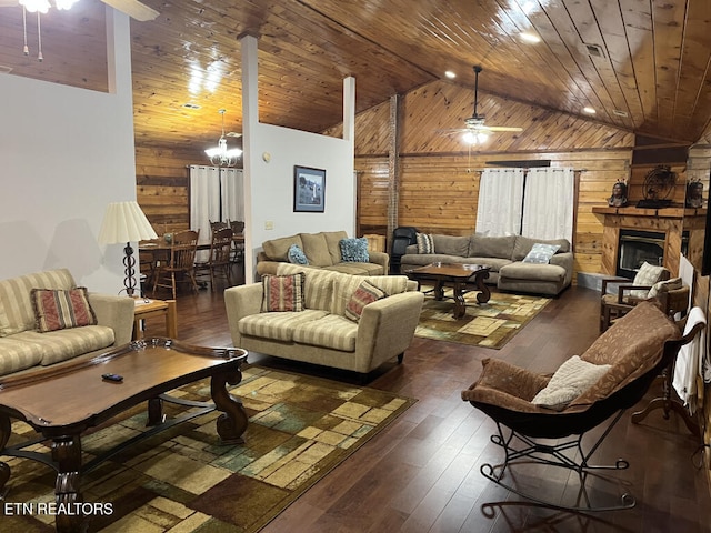 living room featuring wooden ceiling, hardwood / wood-style flooring, a ceiling fan, and wood walls