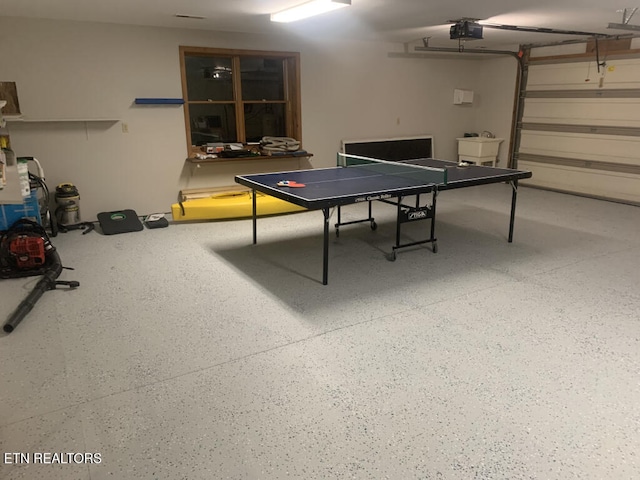 playroom featuring a garage, speckled floor, and a sink