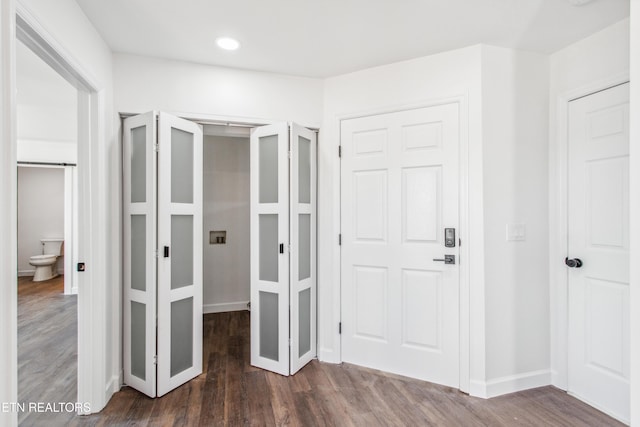 unfurnished bedroom with dark wood finished floors and baseboards