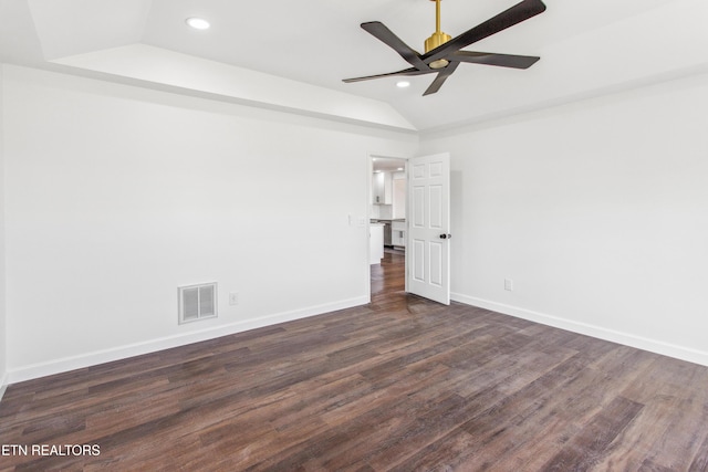 unfurnished room with visible vents, dark wood-type flooring, baseboards, ceiling fan, and vaulted ceiling