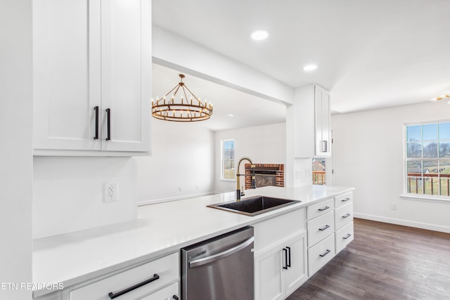 kitchen featuring a sink, white cabinets, light countertops, dishwasher, and dark wood-style flooring