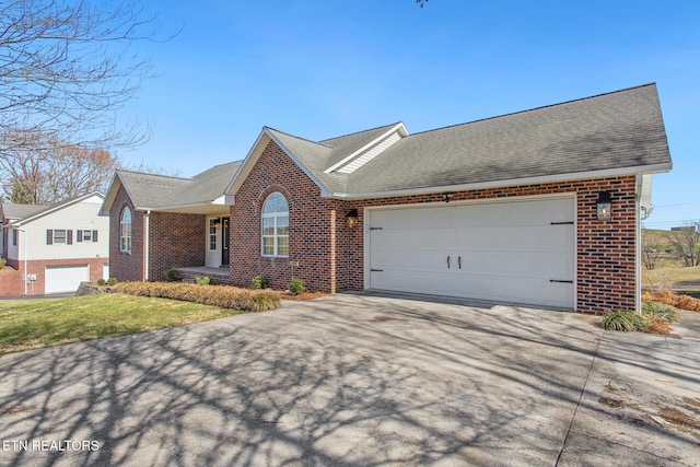 ranch-style home featuring concrete driveway, brick siding, and a shingled roof