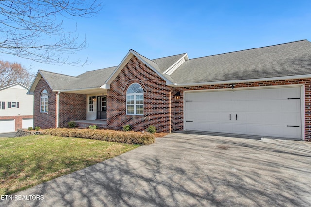 ranch-style home with brick siding, driveway, and a garage