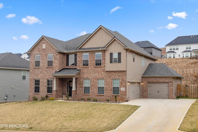 view of front facade with a front yard, fence, brick siding, concrete driveway, and board and batten siding