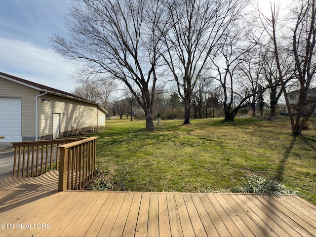 deck with an outbuilding, a yard, and a garage