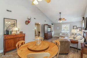 8836 Nubbin Ridge Rd, Knoxville, TN 37923 - dining area with visible vents, high vaulted ceiling, a ceiling fan, and wood finished floors