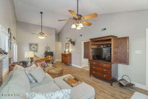 8836 Nubbin Ridge Rd, Knoxville, TN 37923 - living room featuring wood finished floors, high vaulted ceiling, baseboards, and a ceiling fan