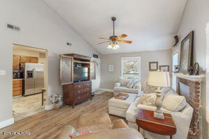 8836 Nubbin Ridge Rd, Knoxville, TN 37923 - living room featuring visible vents, baseboards, a ceiling fan, wood finished floors, and vaulted ceiling