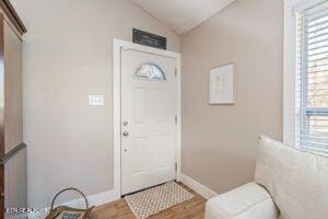 8836 Nubbin Ridge Rd, Knoxville, TN 37923 - entrance foyer featuring lofted ceiling, baseboards, and wood finished floors