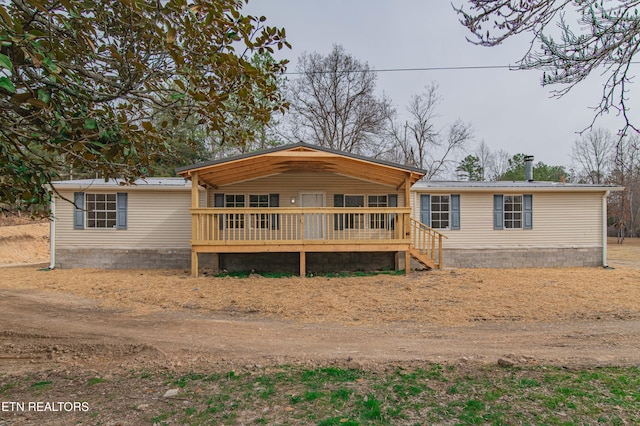 manufactured / mobile home featuring metal roof and a deck