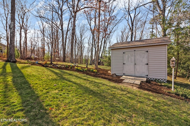 view of yard with a storage unit and an outbuilding