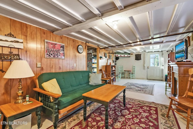 living area with wooden walls and finished concrete floors