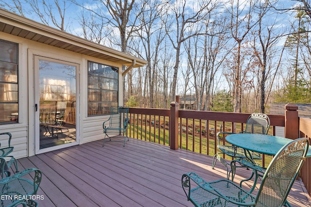 wooden terrace with outdoor dining area