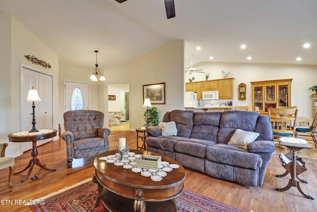 living area featuring wood finished floors, recessed lighting, a ceiling fan, and vaulted ceiling